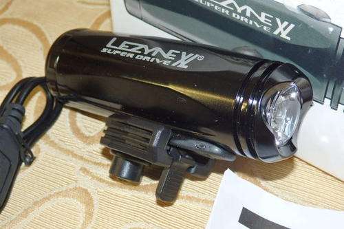 AN AMAZING LEZYNE SUPER DRIVE XL "CYCLE FRONT LIGHT" IN ITS ORIGINAL BOX = NEVER USED