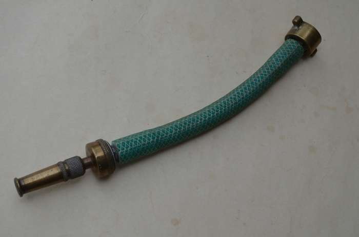 Brass antique hose pipe adjustable cone spray nozzle with the garden tap attachment. A nice prop.