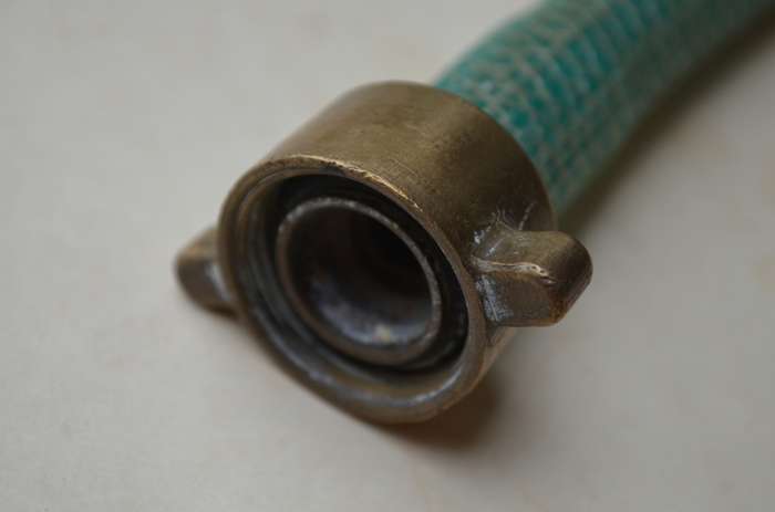 Brass antique hose pipe adjustable cone spray nozzle with the garden tap attachment. A nice prop.