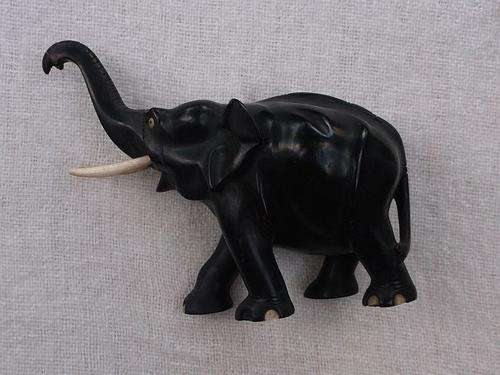 A MARVELOUS VINTAGE SOLID WOOD ELEPHANT CARVING WITH GENUINE BONE TUSKS AND INLAYS ....NICE !!