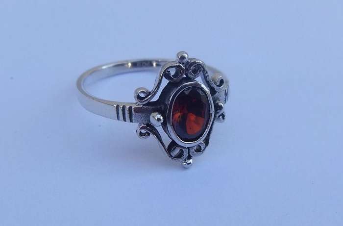 A VERY STYLISH SOLID STERLING SILVER RING SET WITH AN EYE CATCHING FACETED RED STONE !! WOW !!