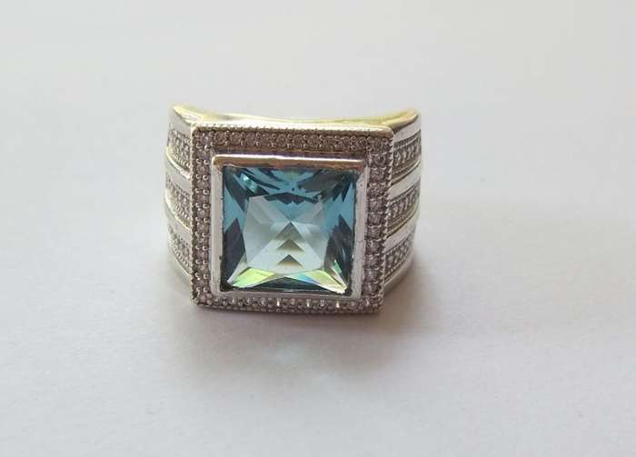 A SUPERIOR QUALITY SOLID STERLING SILVER RING SET WITH A BEAUTIFULLY FACETED BLUE STONE AND MORE !!