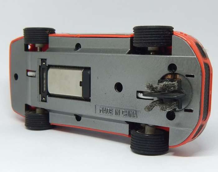 A vintage scalextric car with advertising , driver with co-driver aka navigator
