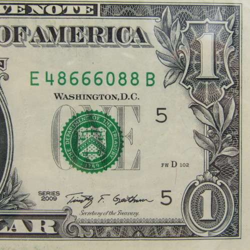 Pair of USA dollar bills with numbers that read the same in reverse