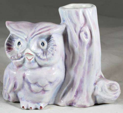 Purple owl with hollow tree stump