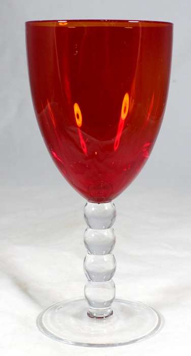 Large red glass on a bubbled stem