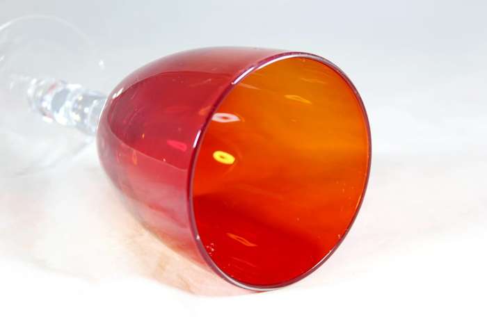 Large red glass on a bubbled stem
