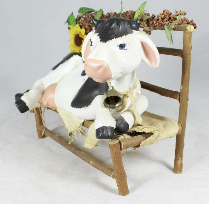 Cow laying on a wooden bench