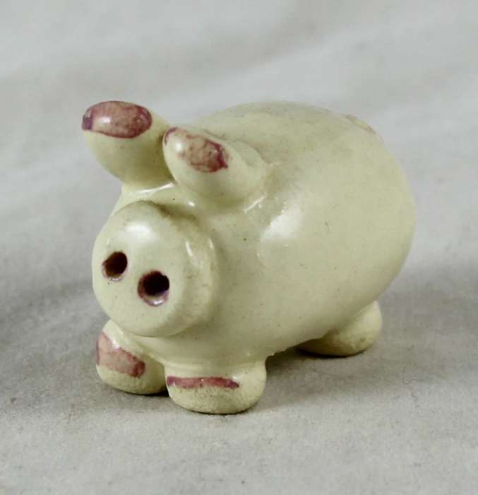 Small beige pig with pink ears