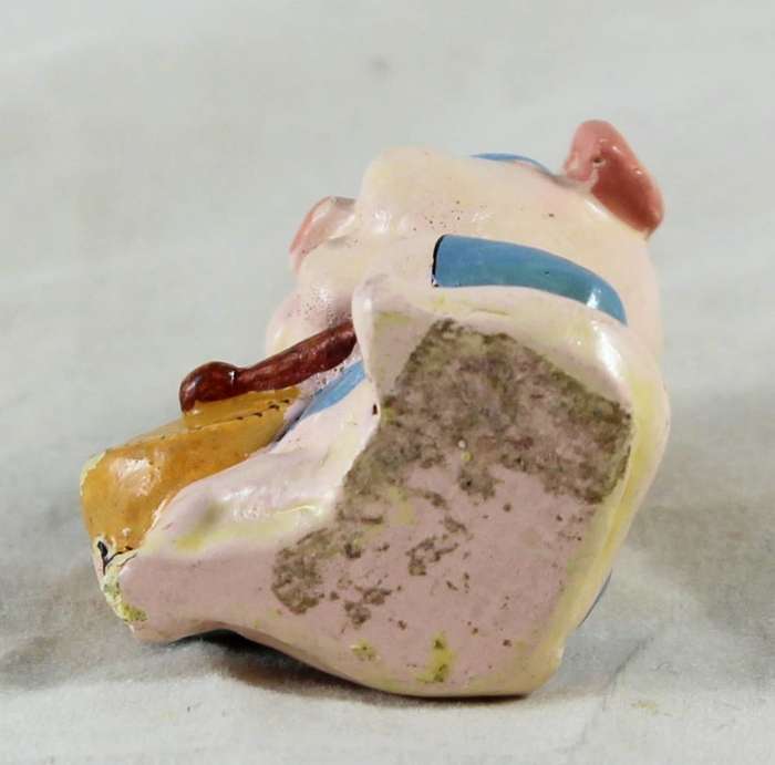 Small pig playing a drum