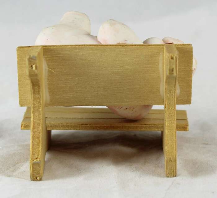 Quirky pig laying on bench