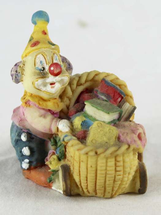 Small clown with books in crib
