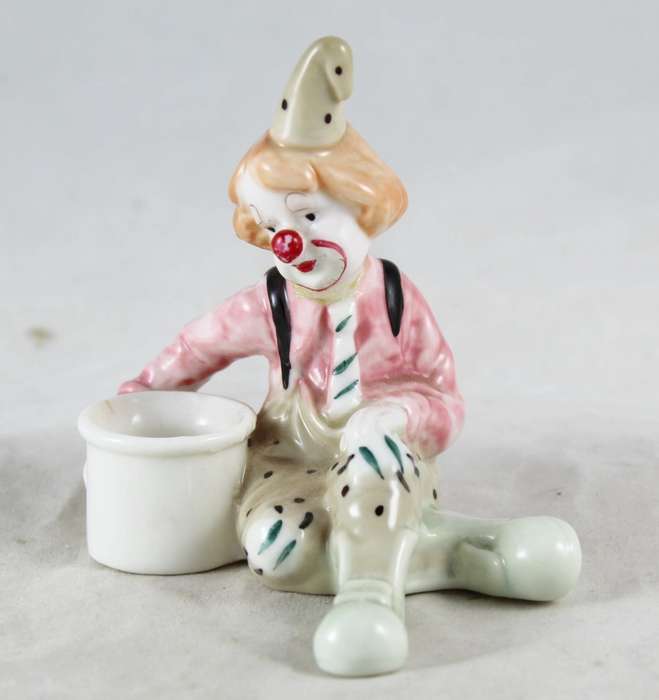 Small Clown Sitting Next To Drum