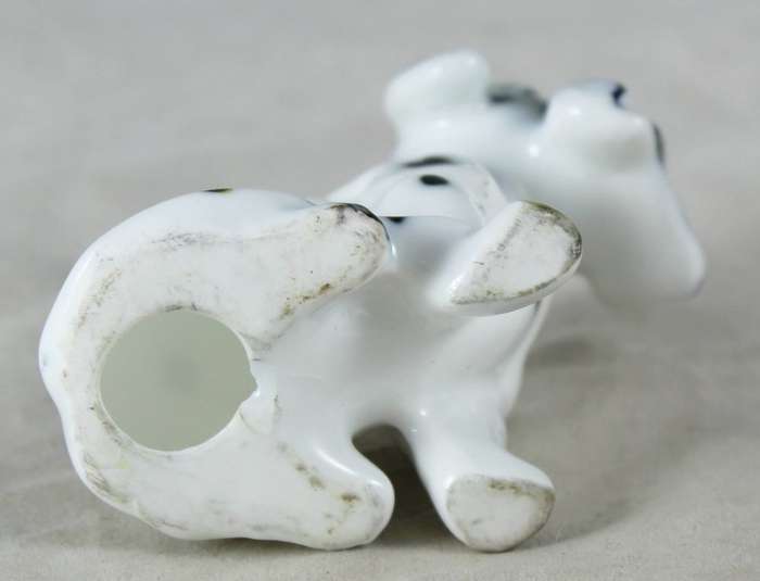 Porcelain dog with newspaper