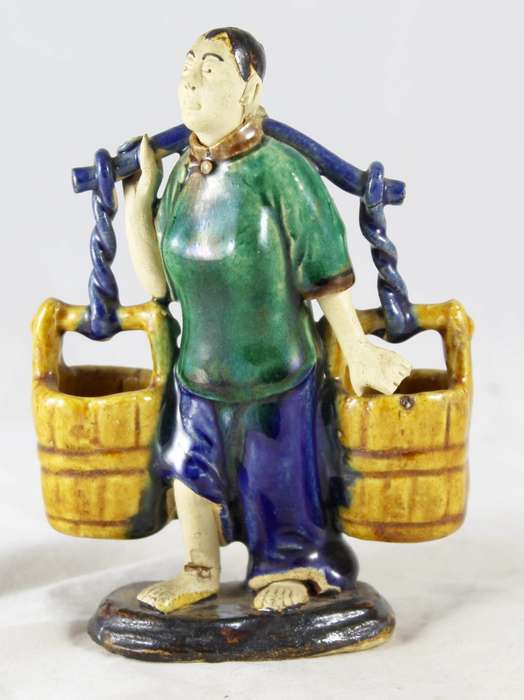 Mud man woman carrying buckets