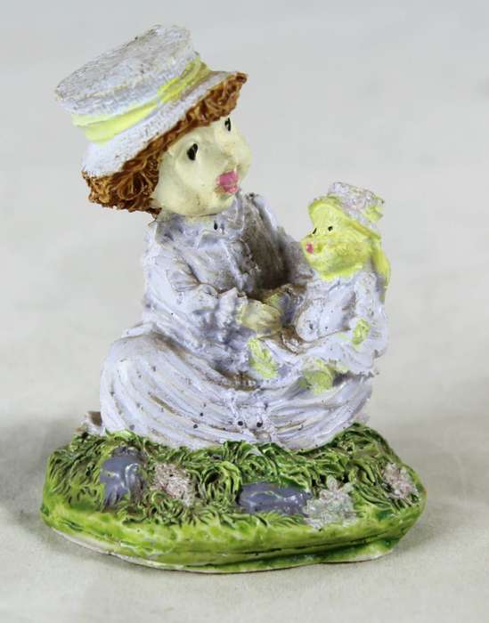 Seated girl with her doll