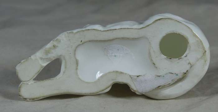 Porcelain small dog lying down