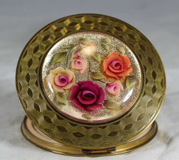 Domed rose embossed powder compact