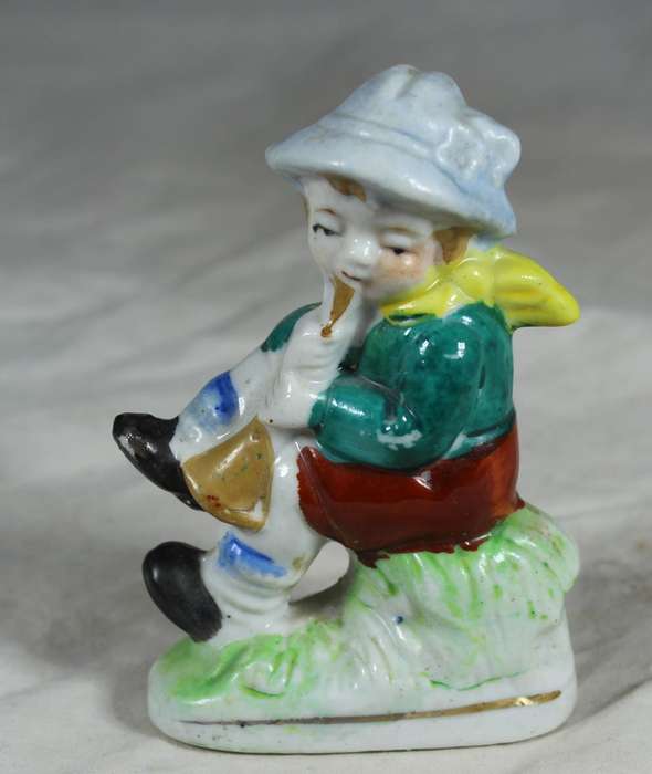 Ceramic boy playing his horn