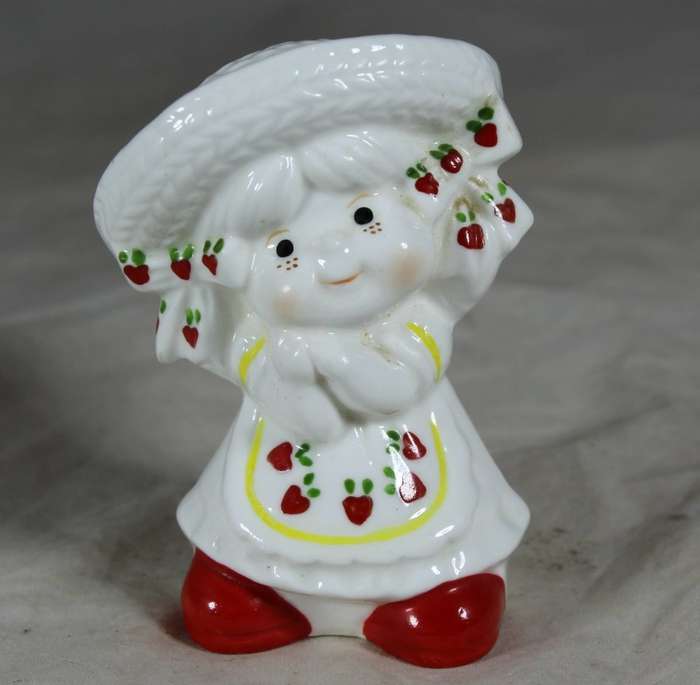 Porcelain happy girl with strawberry dress