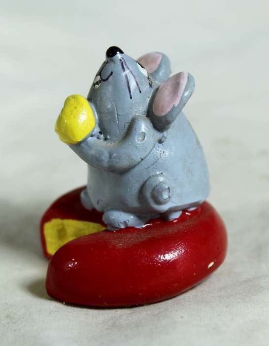 Miniature mouse on cheese