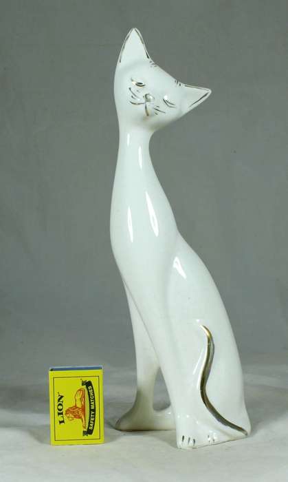 Seated slim white cat