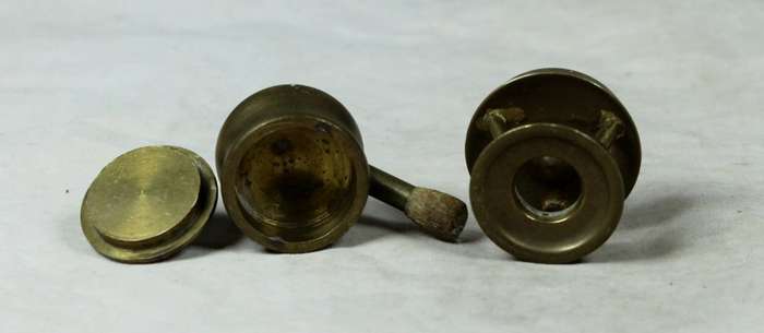 Miniature brass pot on a gas stove