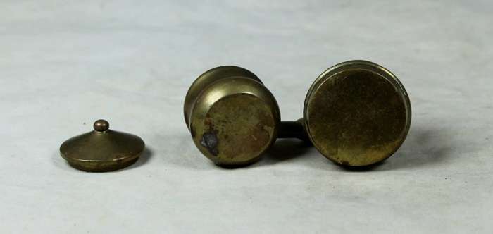 Miniature brass pot on a gas stove