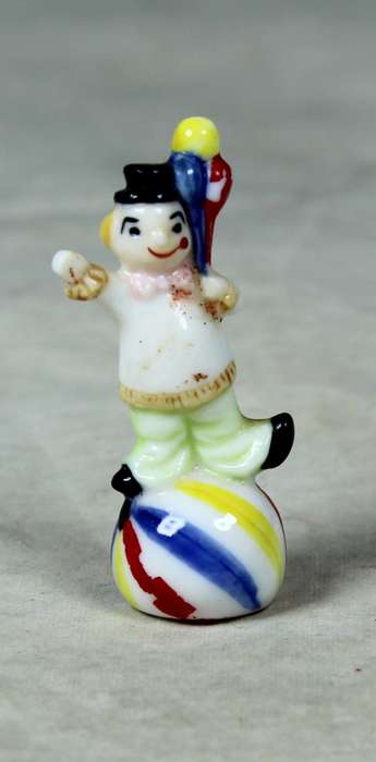 Miniature clown balancing a ball