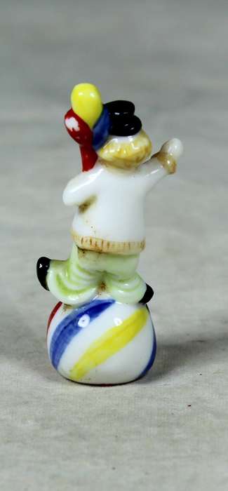 Miniature clown balancing a ball