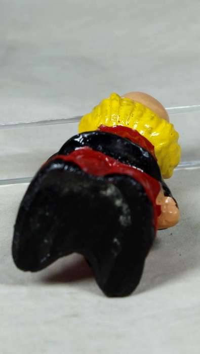 Miniature clown with a blue flower
