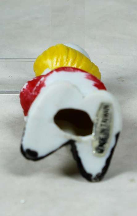 Miniature clown with a yellow flower