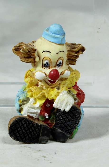 Miniature colorful seated clown