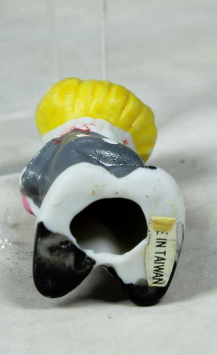 Miniature clown holding a heart