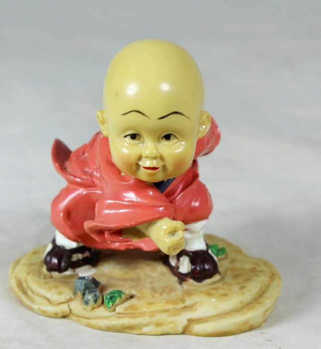 A baby Buddha - Monk practicing martial arts