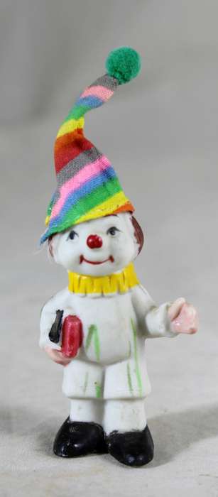 Miniature clown holding books