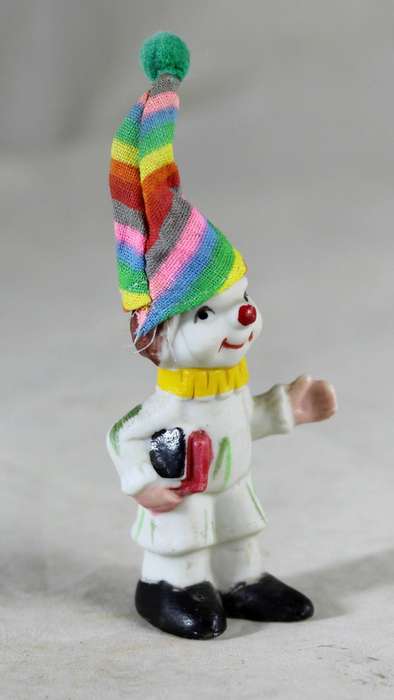 Miniature clown holding books