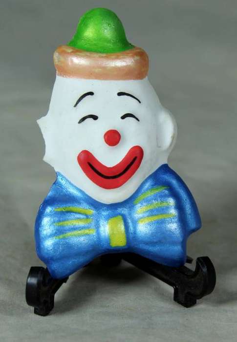 Molded clown face with a blue bow tie