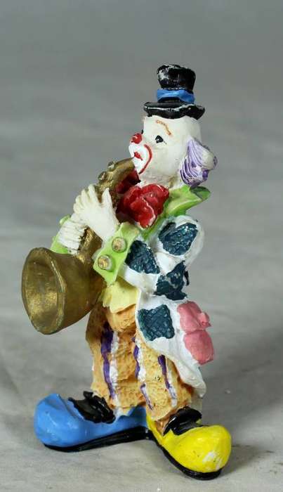 Molded clown playing a trumpet