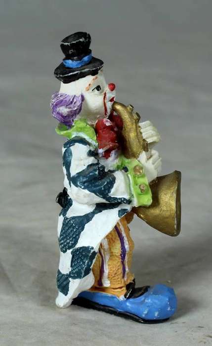 Molded clown playing a trumpet