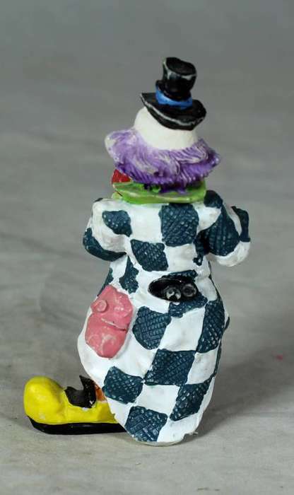 Molded clown playing a trumpet