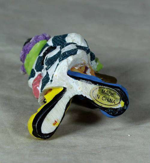 Molded clown playing a trumpet