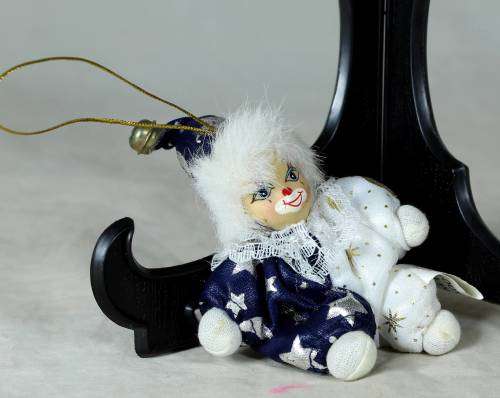 porcelain and cloth clown dressed in a blue&white moon&stars outfit