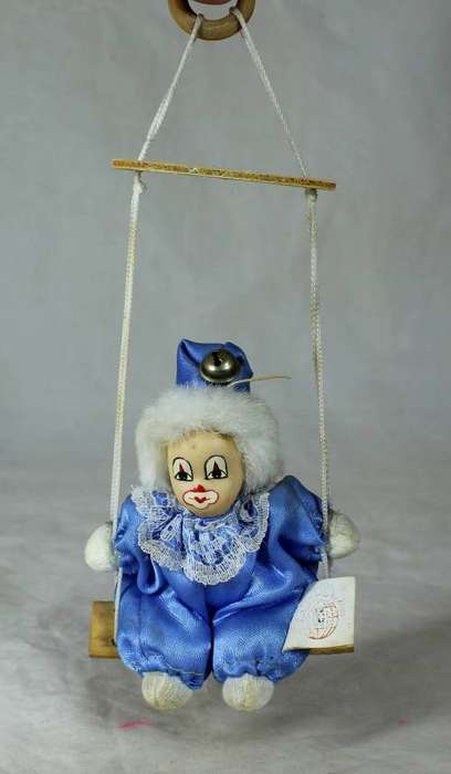 porcelain and cloth clown dressed in blue on a rope