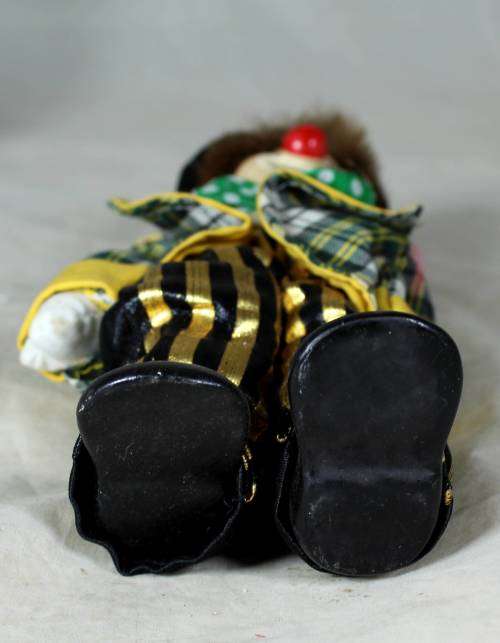 Porcelain and cloth clown in a polka dot tie