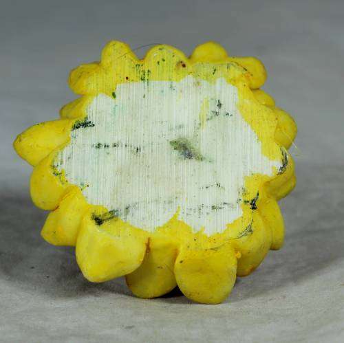 Ceramic clown sitting in a sunflower