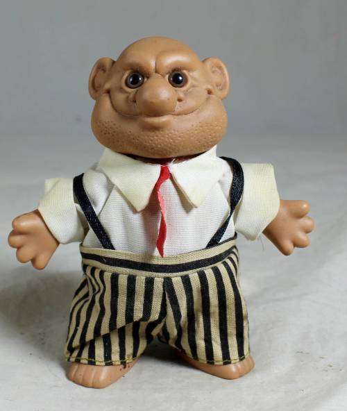Bald Russ troll dressed in a striped pants & a red tie