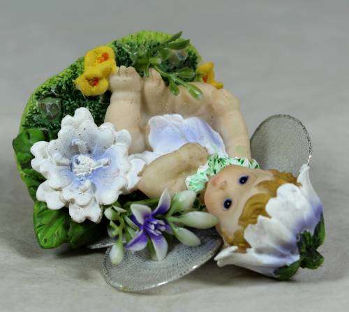 Baby fairy sitting among the flowers