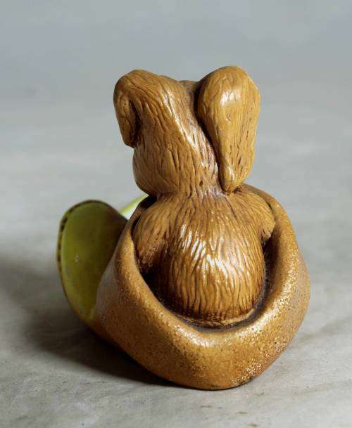 Yellow stone craft rabbit in a glove