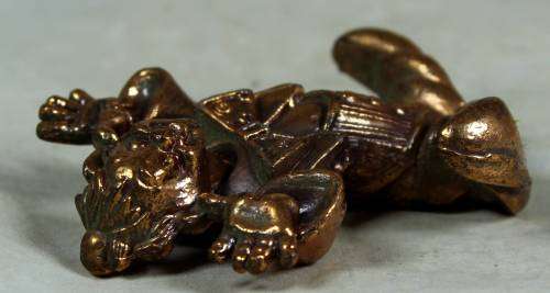 Miniature brass color lead clown with his fingers in his ears